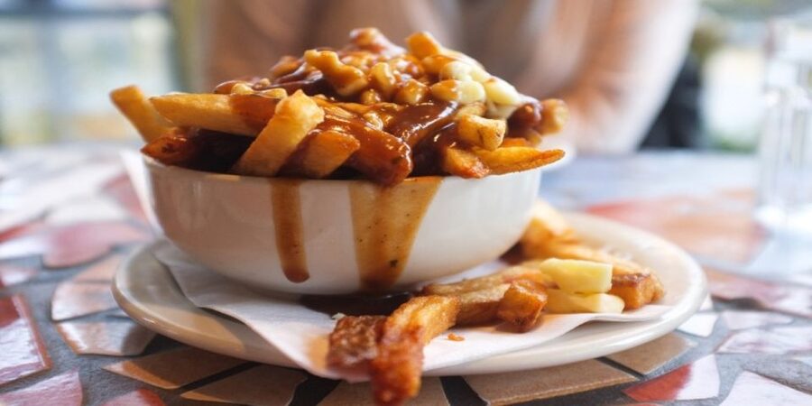 Montreal: Best of Montreal Food Walking Tour with Tastings - Poutine arrives early and fills you up