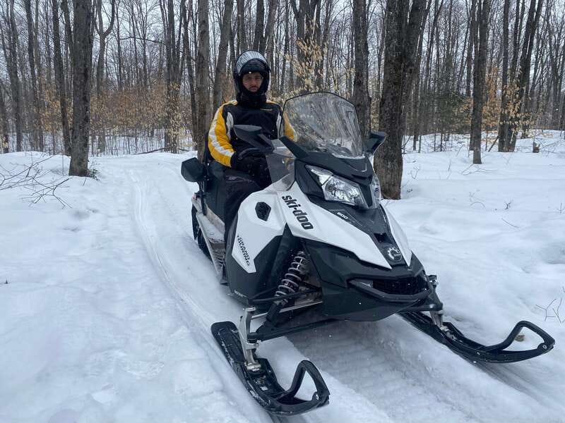 Montreal: Canadian Forest Guided Tour by Snowmobile - Riding through forest toward Olympia Mount
